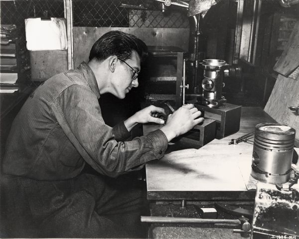 A machinist apprentice at Tractor Works (factory) makes a layout to prepare for machining.