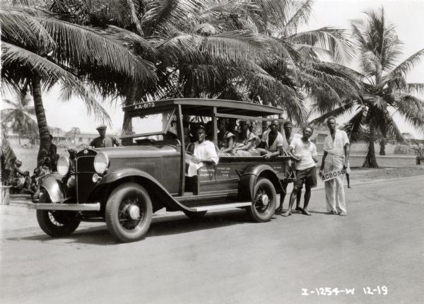 A group from the Gold Coast Colony in Acura(?), West Africa, poses with an International Special Delivery truck. The truck was on an expedition sponsored by International Harvester. The truck later became known as the "truck that crossed the Sahara."