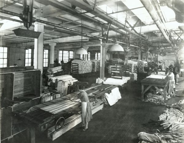 Female factory workers handling fabric strips at McCormick Works.