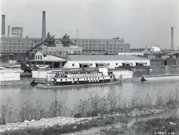 An Island Waterways Corporation boat docks by the North Pier River Barge Terminal near the McCormick Works (factory).