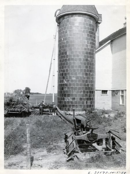 Farmers work with a wagon and silo filler on the farm of W.P. Progovsky.