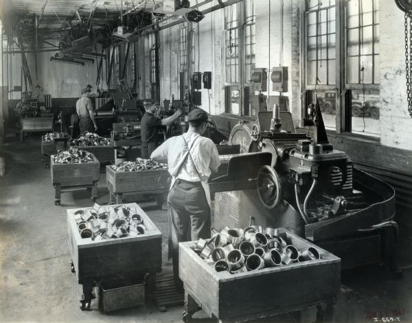Factory workers with machines and parts at West Pullman Works.