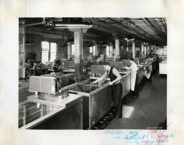 Factory workers assemble milk coolers at the West Pullman Works.