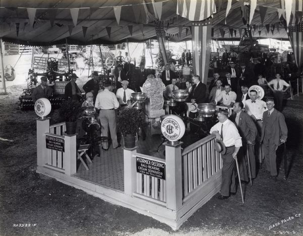 Fairgoers gather around the McCormick-Deering ball-bearing cream separator display at the Indiana State Fair.
