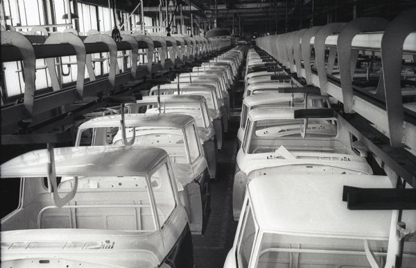 Cabs for International trucks move along ceiling conveyors at International Harvester's Springfield Works factory.