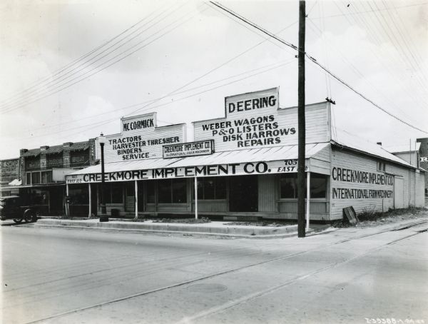 Exterior view of the Creekmore Implement Company, an International Harvester dealership located at 705 East 10th Street.