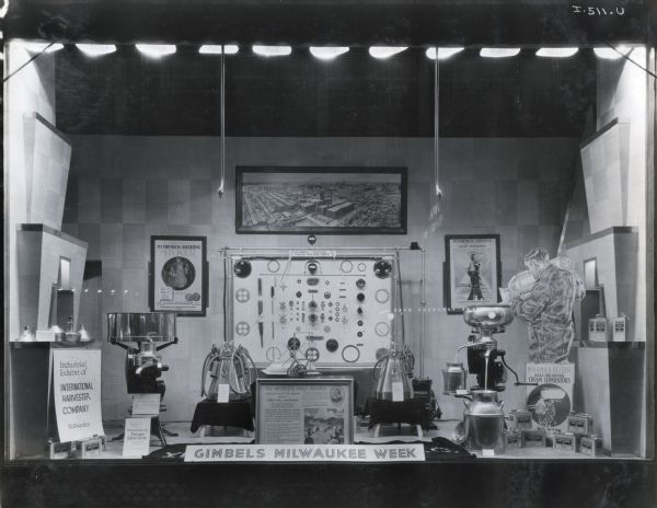 Cream separators, milking machines, parts and International Harvester advertising on display behind a sign reading: "Gimbels Milwaukee Week" in the show window of the Gimbels Brothers Store.