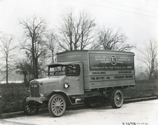 International Model 63 truck operated by The Eavey Co. Printed on the side of the truck is: "Wholesale Grocers" "Xenia, Ohio" "Sturgis, Michigan" "Fort Wayne, Indiana" "Richmond, Indiana" "Distributors of Pure Food Products Since 1869."