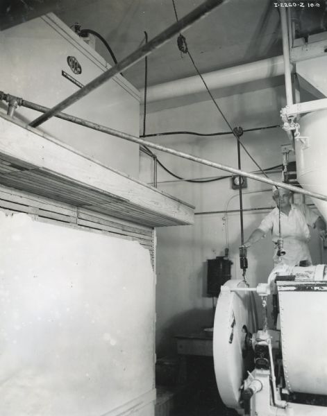 A man works near an 8-can milk cooler at the Columbia Baking Company.