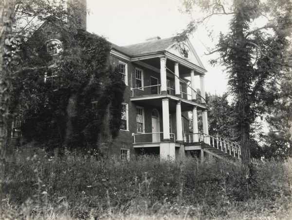 A production still for the Fox Hearst film "Romance of the Reaper," showing the McCormick family home on location in Walnut Grove. The film was produced by International Harvester to celebrate the Reaper Centennial.