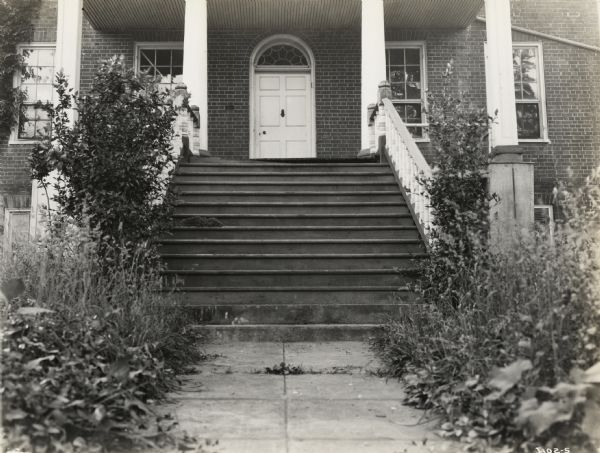 A production still for the Fox Hearst film "Romance of the Reaper" showing the front steps of the McCormick family home. The film was produced by International Harvester to celebrate the Reaper Centennial.