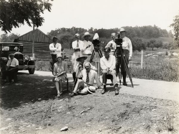 A production still for the Fox Hearst film "Romance of the Reaper". The film was produced by International Harvester at Walnut Grove to celebrate the Reaper Centennial. A group of men and women (possibly cameramen and other members of the film crew) on location during the filming of "Romance of the Reaper."