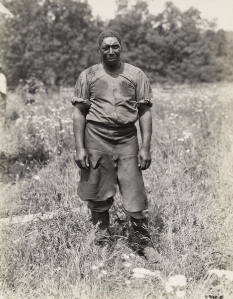 A production still for the Fox Hearst film "Romance of the Reaper." The film was produced by International Harvester at Walnut Grove to celebrate the Reaper Centennial. Harry Wilson, who played the role of Jo Anderson, stands in a field.