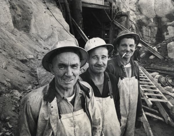 Construction workers O.R. Williams, Fred Mappin, and Rober Garner at the site of the Mammoth Pool Dam on the San Joaquin River in the Sierra Nevada Mountains.