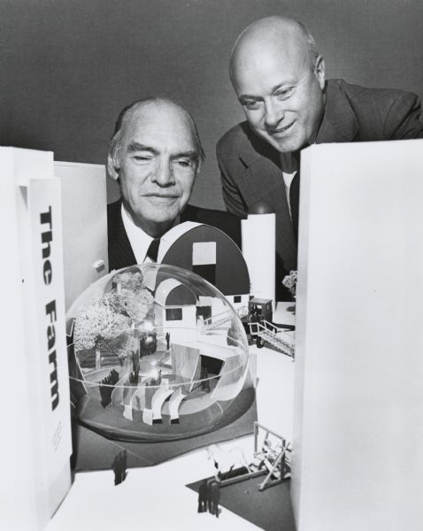 Daniel M. McMaster, president of the Chicago Museum of Science and Industry, and Keith R. Potter, executive vice president of International Harvester, view a model of a planned exhibit for the museum. The "Agrisphere" exhibit was financed by International Harvester and replaced an earlier agricultural exhibit, also sponsored by the company. The exhibit depicted the historical progress of agriculture and featured numerous International Harvester products and a theatre housed in a geodesic dome.