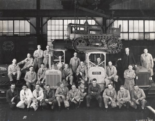 A group portrait of Eastern District branch service managers at Tractor Works (factory). Original caption reads: "Tractor Works, Service managers, Eastern District, Week of Nov. 11-1935. Taken by McQuinn".