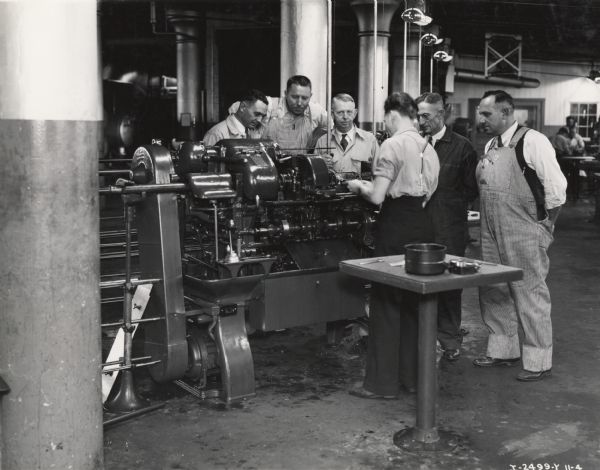 Southwest District branch service managers touring the factory floor at Milwaukee Works. Original caption reads: "Milwaukee Works, Some of the group of Service Managers from S.W. District visiting tractor plants week of 10-10-1935. Taken by McQuinn".