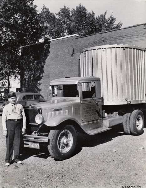 Truck driver W.A. Orell standing next to his International truck. Original caption reads: "W.A. Orell - Safety driver." A painted sign on the door reads: "The Silver Fleet of Memphis Inc." The driver's hat also reads: "Silver Fleet". Mr. Orell was likely the recipient of a safe-driving award sponsored by International Harvester.