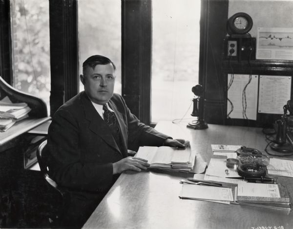 Springfield Works storekeeper H.H. Stephenson sits at a desk in his factory office.