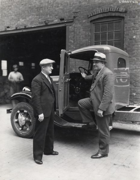 S.A. Young and Chief Inspector A.W.H. Lee of International Harvester's Springfield Works stand next to an International truck near the factory.