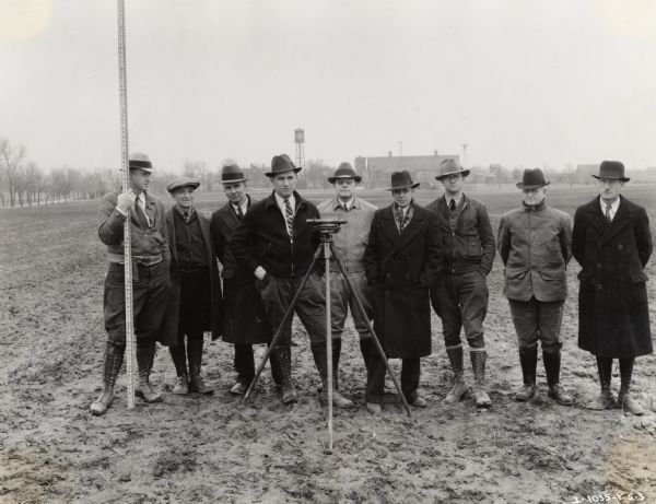 Men from the Illinois Soil Conservation Project stand for a photograph at International Harvester's experimental farm at Hinsdale. Original caption reads: "Hinsdale Farm. Group of men from Illinois soil Conservation project - LeRoy, Illinois. Taken by Yerkes."