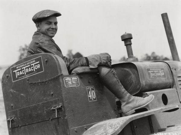 Internatioanl Harvester employee W.A. Guest sits on a McCormick-Deering T-40 TracTracTor (crawler tractor). Original caption reads: "W.A. Guest, salesman and demonstrator, Atlanta branch house, and TD-40 that was being used in county terracing work near Talbottom, Georgia. [Taken by] Hyde and Hawkins."