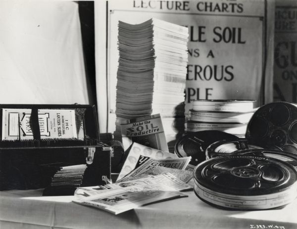 A collection of films, booklets, and lantern slides, likely created by International Harvester's Agricultural Extension Department.
