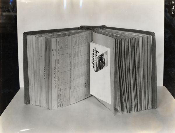 Scrap book of advertising literature for International trucks and other machinery. The scrap book, or sample book, was created by the company's Advertising Department as an ongoing record of their advertising campaigns. The sample books ended up in the company's Corporate Archives and became known as "bluebooks".