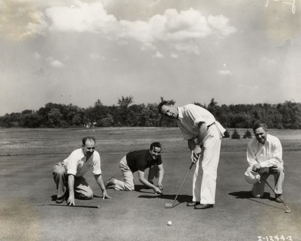 Original caption reads: "Golf party held June 17, 1936, at the Brierhill Country Club. A select group of National Account buyers. Left to right: C. Koenig, sales manager, Borden Milk Company; W.A. Baril, executive vice president, Borden Milk Company; Folwer McCormick, vice president, International Harvester Company; and T.J. Maloney, traffic manager, International Harvester Company."