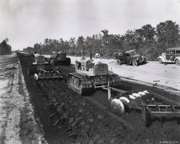 Three TD-40 TracTracTors (crawler tractors) and a TD-18 help construct Route 39 in western Florida. The tractors were owned by Smith Engineering and Construction Company of Pensacola.