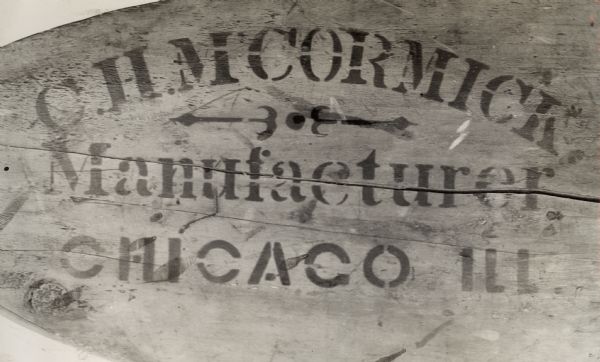 Stenciling on an 1849 McCormick reaper. The text reads: "C.H. M'CORMICK Manufacturer Chicago Ill."