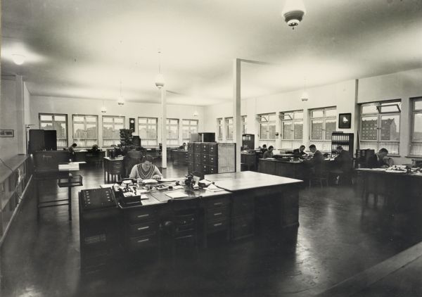 Office workers at desks in International Harvester's Hamburg branch house in Germany.