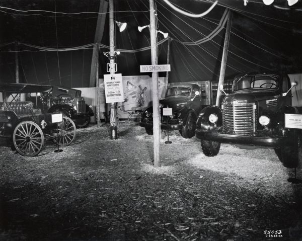 Four International trucks on display in a large tent at the Pacific Logging Congress in Seattle, Washington. The event was held from November 17-19, 1947.