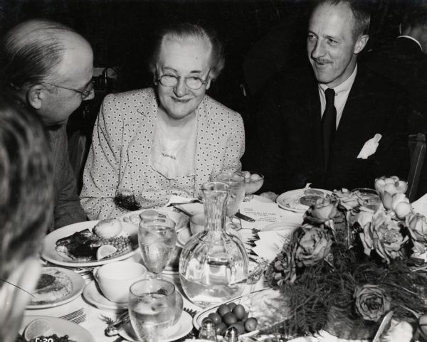 From left to right, J.L. McCaffrey, President of International Harvester; Anita McCormick Blaine; Fowler McCormick, Chairman of the Board for International Harvester. The three are likely at a dinner relating to International Harvester's "100 Years in Chicago" celebration.