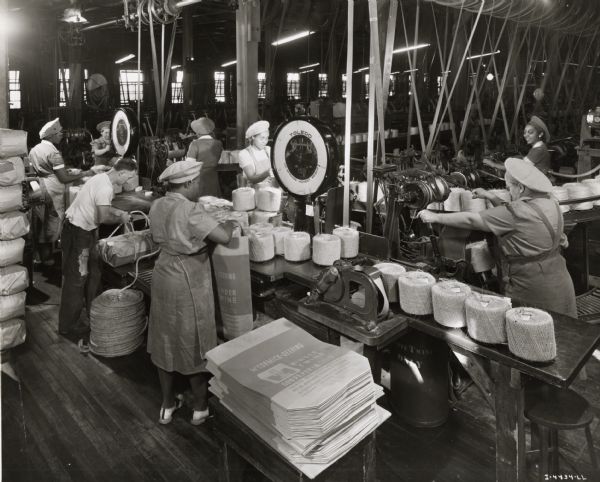 Factory workers weigh and pack twine, possibly at the McCormick Twine Mill.