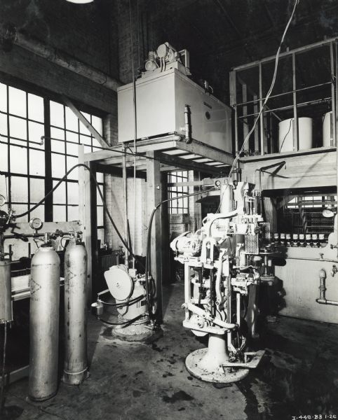 A McCormick-Deering Cooler installation in a Pepsi-Cola bottling plant. The cooler is mounted on a raised platform.