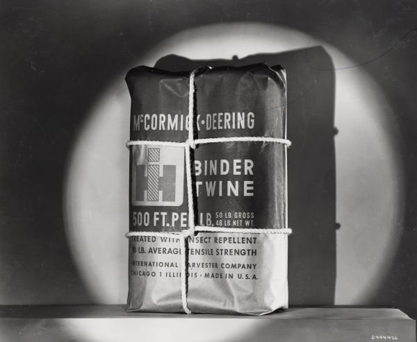 A bound bag of McCormick-Deering binder twine sits on a table for display.