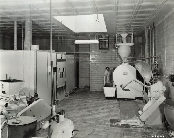 Worker at Mary Lou Bakery. Original caption states:  "12BBW Water Cooler. Bakery installation and dough conditioning application."
