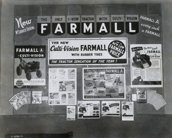 Bulletin board with posters and other advertisements for the Farmall A tractor with "Culti-Vision." The banner reads: "New McCormick-Deering; The Only 1-Row Tractor with Culti-Vision; Farmall A, Every Inch a Farmall."