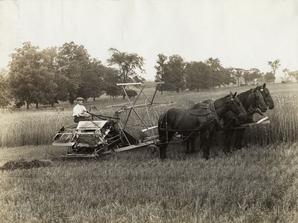 A man operates a horse-drawn Osborne grain binder in a field. A note with the photograph reads: "Emerson Brantingham."