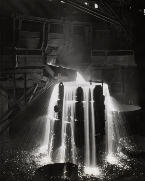 A shower of molten metal at International Harvester's Wisconsin Steel Works (factory).