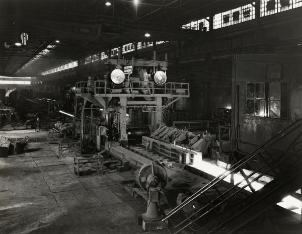 Blooming mill at International Harvester's Wisconsin Steel Works (factory). Original caption reads: "General view of a portion of the new Wisconsin Steel Works blooming mill, with 40" blooming mill in foreground, and crop shear and 32" blooming mill in perspective."