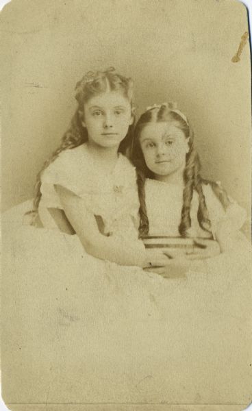 Studio portrait of Mary Virginia (1861-1941) and Anita McCormick (1866-1954) as children. They are wearing dresses and have ribbons in their hair.
