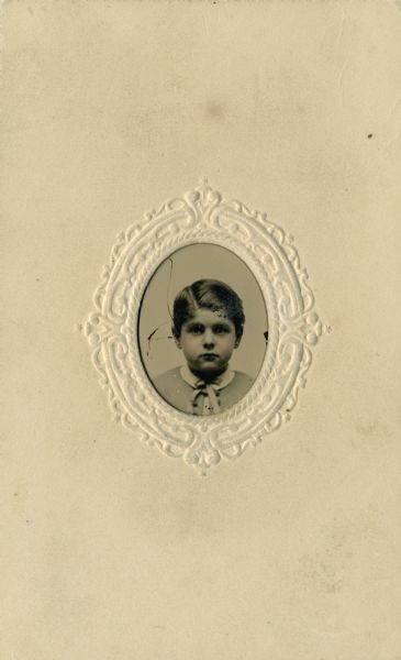 Tinted tintype portrait of Cyrus Hall McCormick, Jr. (1859-1936) as a child. He is wearing a jacket and necktie.