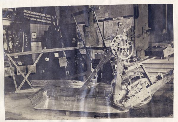 Automatic Corn Reaper, most likely on display at the London Exhibition of 1862. A sign above the reaper suggests that the reaper may be "Russell's."