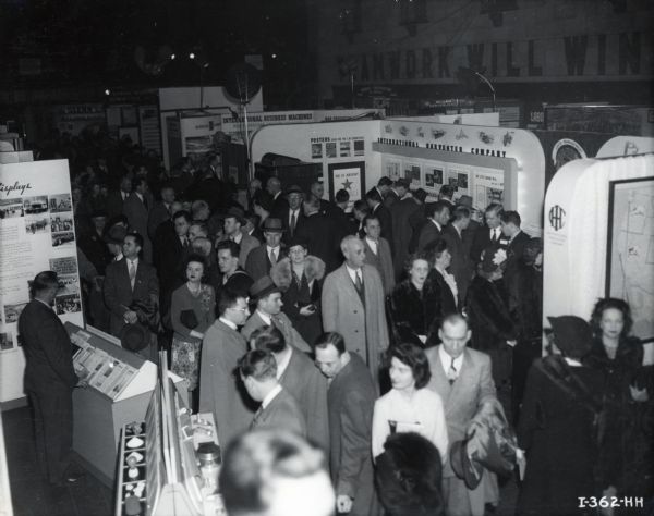 Elevated view of the crowd and exhibits at the opening night of the First National Labor-Management Production Exposition.