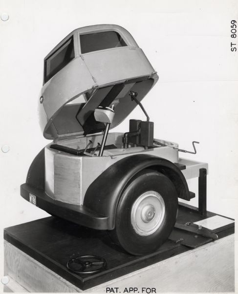 Scale model of an experimental truck "flip cab" shown in an open position. The model was likely produced by an industrial designer.