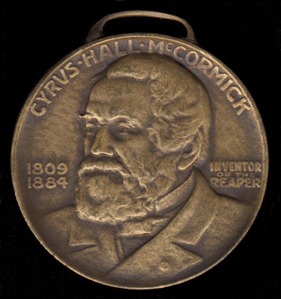 Front side of a coin made for International Harvester to celebrate the "Reaper Centennial." The event commemorated the one hundred year anniversary of the testing of the first reaper by Cyrus Hall McCormick.