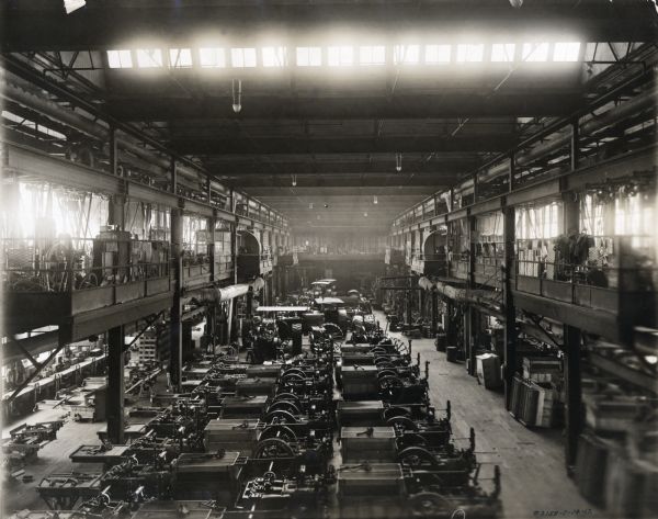 Tractors and engines(?) in the machine shop in Building #40 at International Harvester Company's Milwaukee Works (factory).