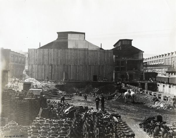 Men clearing ground at International Harvester's Milwaukee Works factory for the addition of a six-story machine shop.